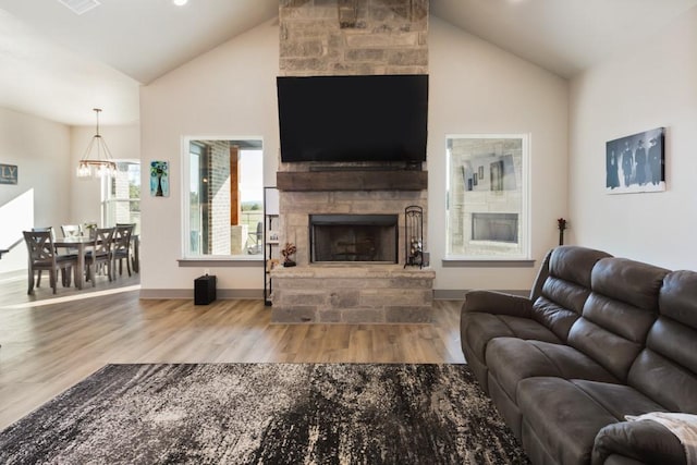 170 Rolling Hills Blvd, Alvord, TX 76225 - living area featuring a stone fireplace, wood finished floors, baseboards, high vaulted ceiling, and a notable chandelier