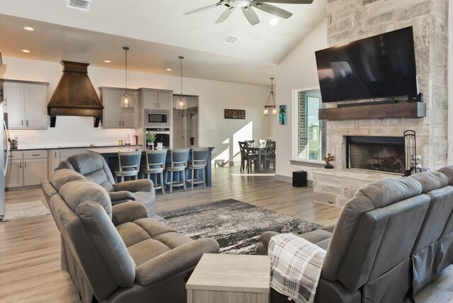 170 Rolling Hills Blvd, Alvord, TX 76225 - living area featuring ceiling fan, a fireplace, light wood-style floors, high vaulted ceiling, and recessed lighting