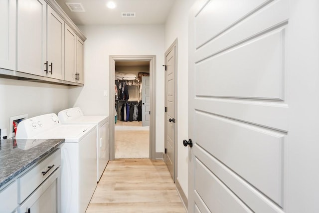 170 Rolling Hills Blvd, Alvord, TX 76225 - laundry room featuring light wood-style floors, washing machine and dryer, cabinet space, and visible vents