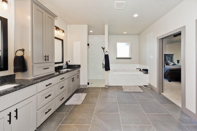 170 Rolling Hills Blvd, Alvord, TX 76225 - bathroom with double vanity, a garden tub, visible vents, a tile shower, and a sink