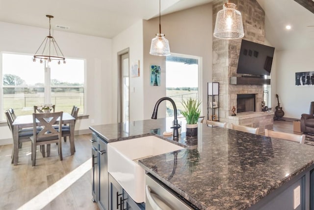 170 Rolling Hills Blvd, Alvord, TX 76225 - kitchen with a fireplace, a notable chandelier, a sink, light wood finished floors, and open floor plan