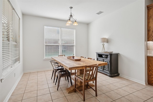 dining area featuring baseboards, visible vents, and light tile patterned floors
