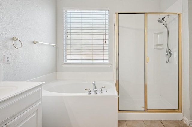bathroom with vanity, a stall shower, tile patterned floors, and a bath
