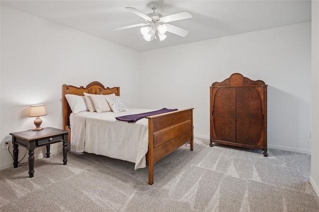 carpeted bedroom featuring baseboards and a ceiling fan