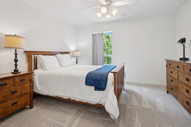 bedroom featuring baseboards, ornamental molding, ceiling fan, and light colored carpet