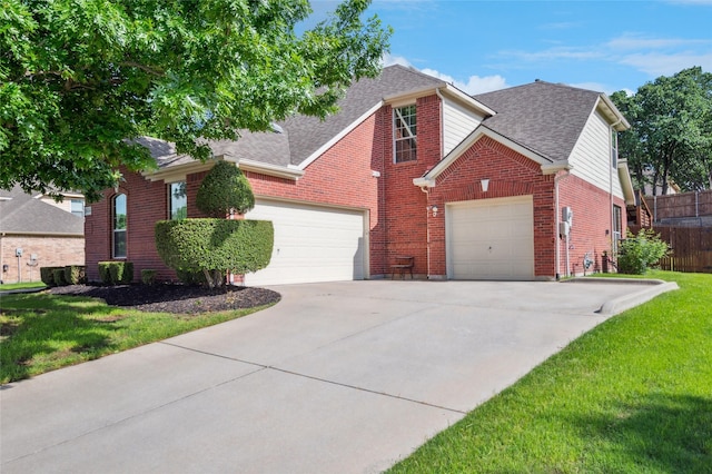 traditional home with roof with shingles, an attached garage, concrete driveway, and brick siding
