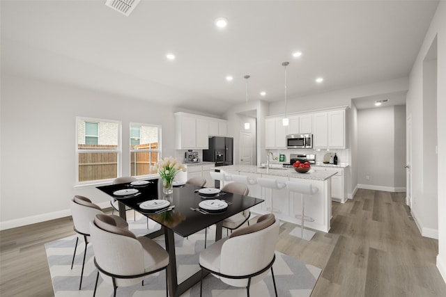 510 Reatta Dr, Justin, TX 76247 - dining room with light wood-style flooring and recessed lighting