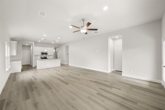 510 Reatta Dr, Justin, TX 76247 - unfurnished living room with recessed lighting, ceiling fan, and light wood-style floors