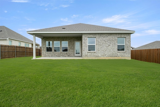 510 Reatta Dr, Justin, TX 76247 - back of property featuring a fenced backyard, a patio area, brick siding, and roof with shingles