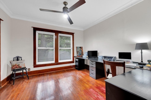 office space with baseboards, ceiling fan, ornamental molding, and light wood-type flooring