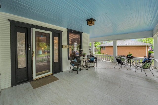 wooden terrace featuring outdoor dining area