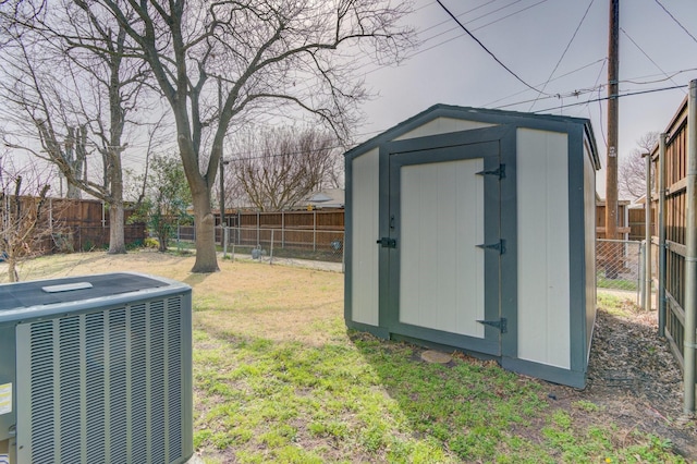 view of shed with a fenced backyard and central AC