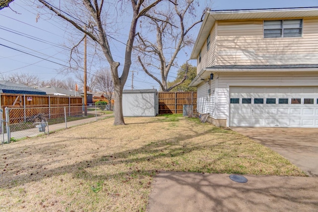 view of yard featuring fence and a garage