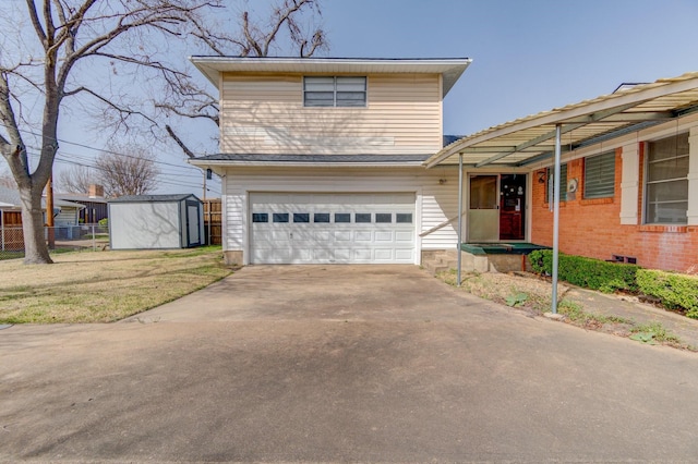 view of front of home featuring a front lawn, fence, a shed, concrete driveway, and an attached garage