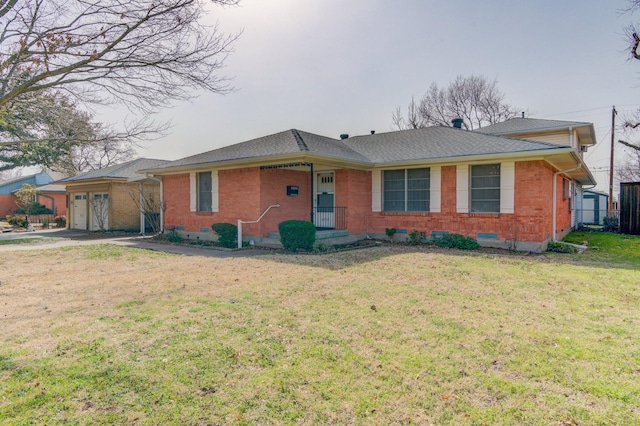 ranch-style home featuring roof with shingles, an attached garage, brick siding, driveway, and a front yard