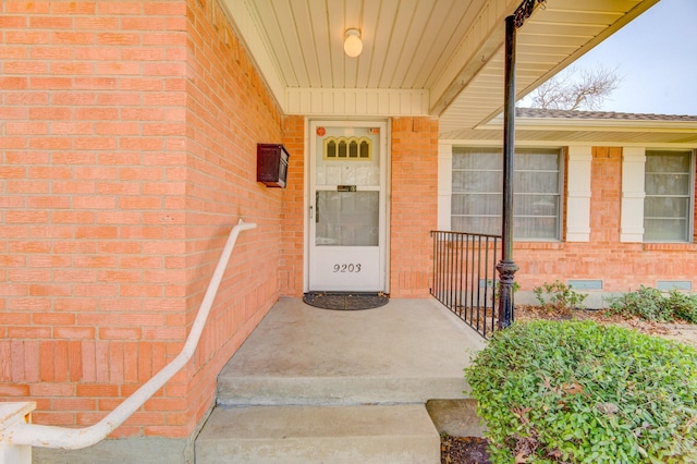 property entrance featuring brick siding