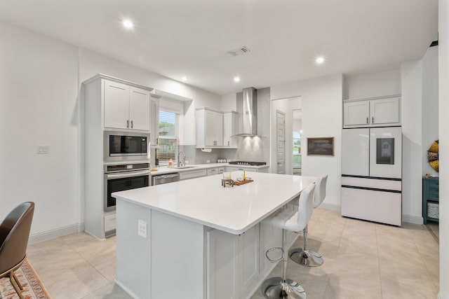 5617 Winona Ln, Mckinney, TX 75071 - kitchen featuring stainless steel appliances, wall chimney range hood, a sink, a kitchen island, and light countertops