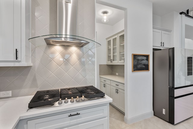 5617 Winona Ln, Mckinney, TX 75071 - kitchen featuring appliances with stainless steel finishes, wall chimney exhaust hood, light countertops, decorative backsplash, and light tile patterned flooring