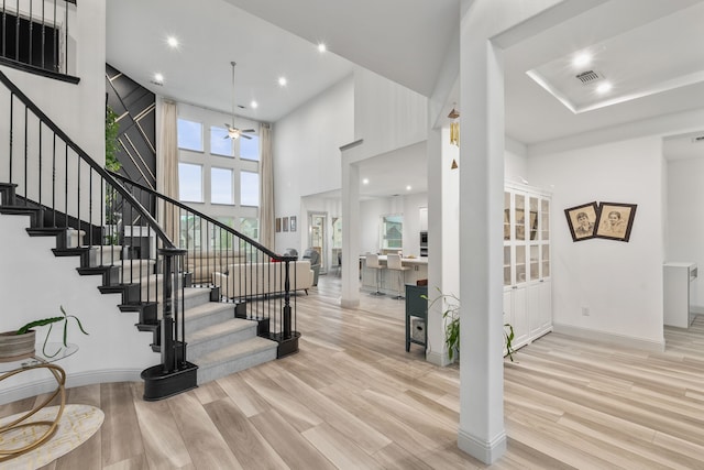 5617 Winona Ln, Mckinney, TX 75071 - entrance foyer featuring wood finished floors, stairway, a ceiling fan, recessed lighting, and a high ceiling