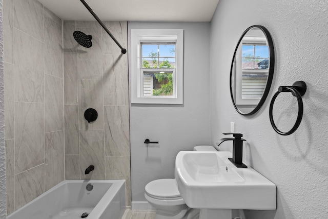 bathroom featuring shower / bath combination, baseboards, and toilet