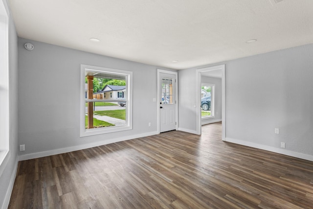 interior space featuring baseboards and wood finished floors