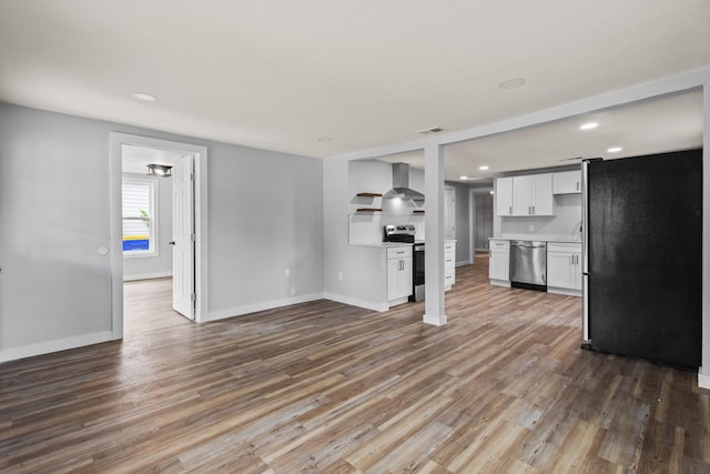 unfurnished living room with baseboards, wood finished floors, and visible vents