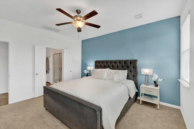 bedroom with visible vents, a ceiling fan, and light colored carpet