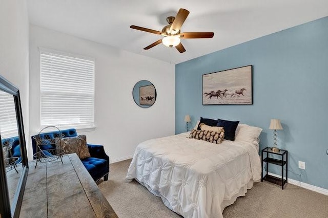 carpeted bedroom with baseboards and a ceiling fan
