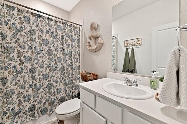 full bathroom with vanity, a shower with shower curtain, and toilet