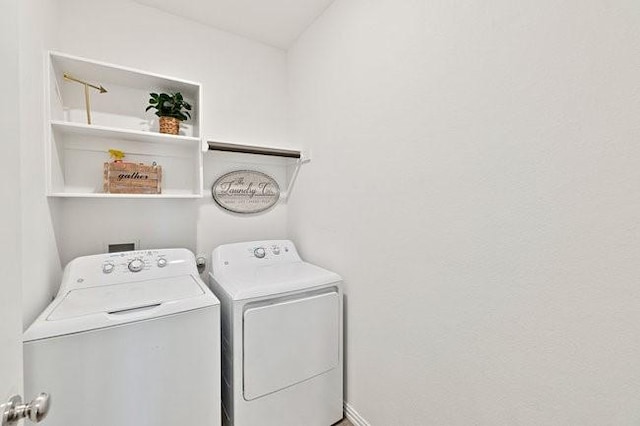 washroom featuring laundry area and washing machine and clothes dryer
