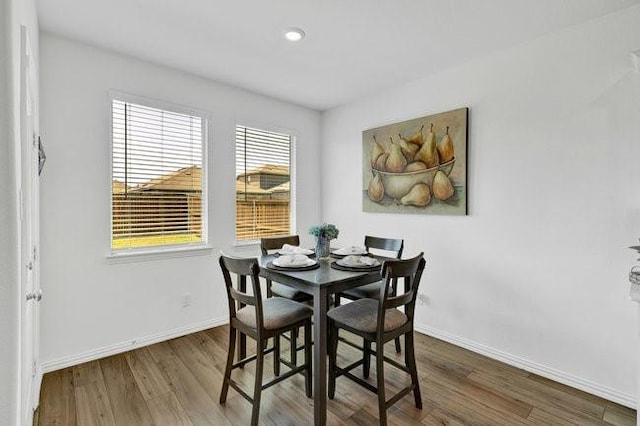 dining room with baseboards, recessed lighting, and wood finished floors