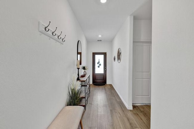 doorway to outside featuring recessed lighting, light wood-style flooring, baseboards, and visible vents