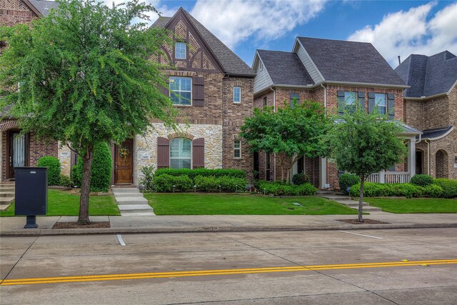 7401 Collin Mckinney Pkwy, Mckinney, TX 75070 - view of front of home with brick siding and a front lawn