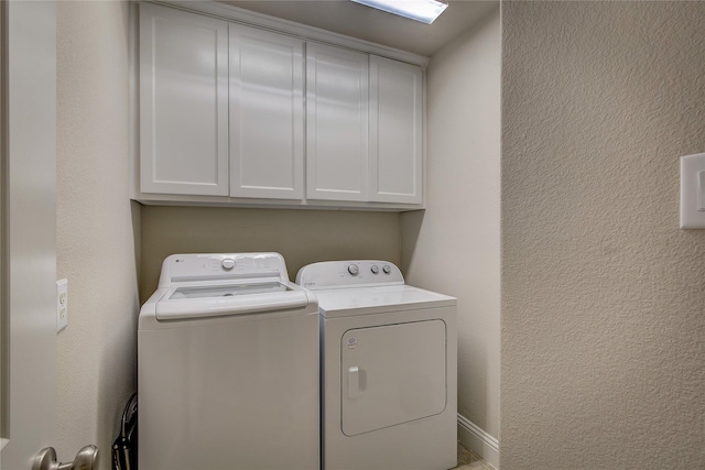7401 Collin Mckinney Pkwy, Mckinney, TX 75070 - clothes washing area featuring washing machine and dryer, cabinet space, and a textured wall