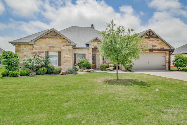 view of front facade with a front lawn, stone siding, a shingled roof, concrete driveway, and an attached garage