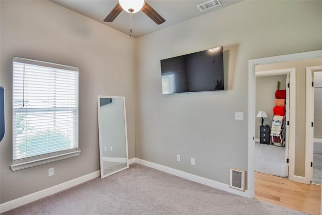 unfurnished bedroom featuring visible vents, baseboards, and multiple windows