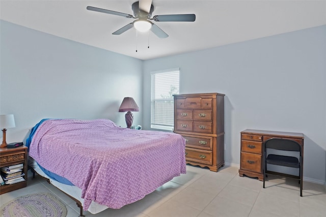 bedroom featuring light tile patterned floors, baseboards, and a ceiling fan