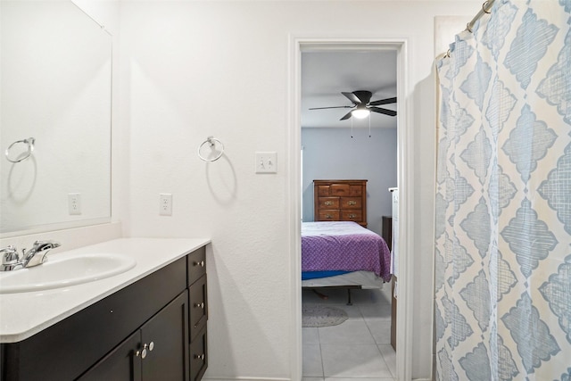 ensuite bathroom with a shower with curtain, a ceiling fan, tile patterned flooring, vanity, and ensuite bath