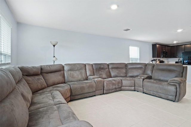 living area with recessed lighting, visible vents, and light tile patterned floors