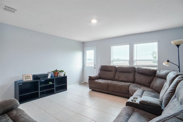 living area featuring light tile patterned flooring, baseboards, and visible vents