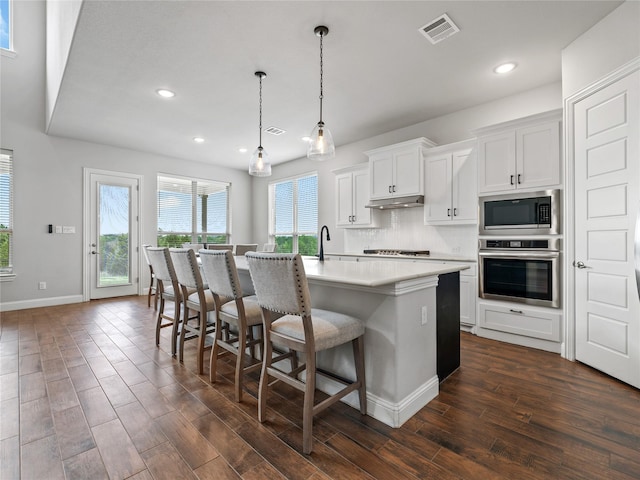 kitchen featuring visible vents, recessed lighting, dark wood-type flooring, and stainless steel appliances