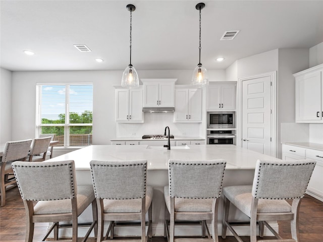 kitchen featuring decorative backsplash, stainless steel appliances, recessed lighting, and visible vents