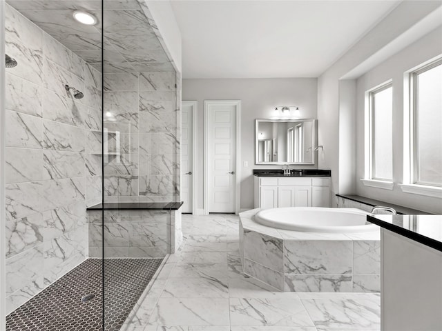 full bathroom with vanity, walk in shower, a garden tub, and marble finish floor