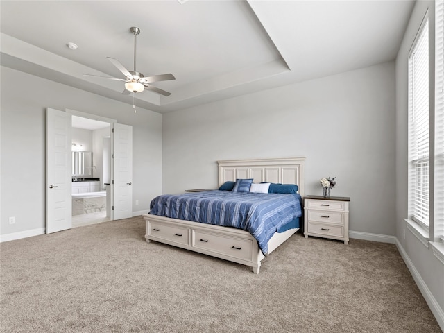 bedroom featuring baseboards, multiple windows, and carpet