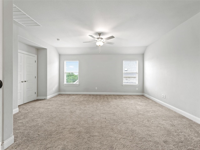 spare room featuring carpet floors, baseboards, and a ceiling fan