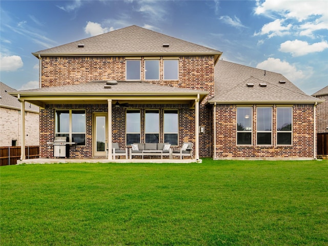 rear view of property featuring brick siding, an outdoor living space, and a patio area