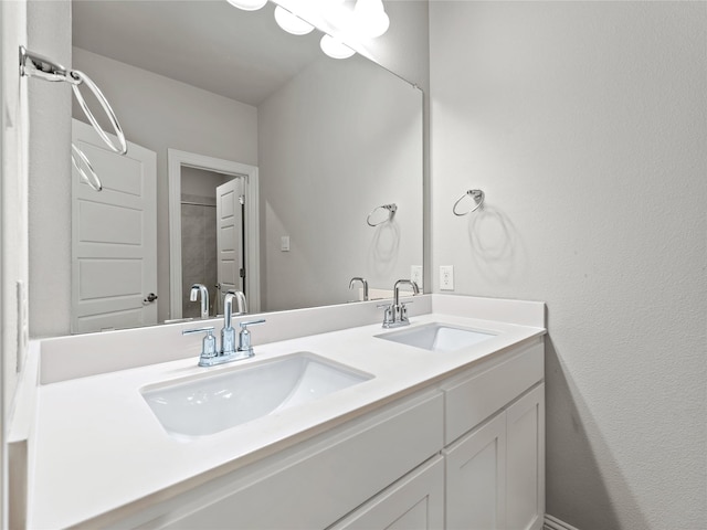 full bathroom with double vanity and a sink