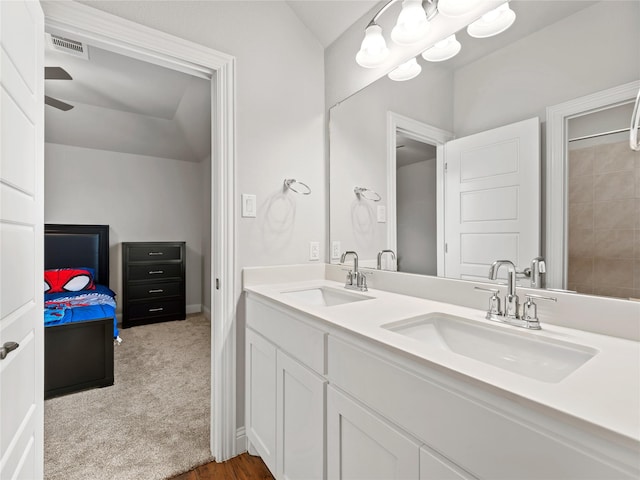 bathroom with visible vents, a sink, baseboards, and double vanity