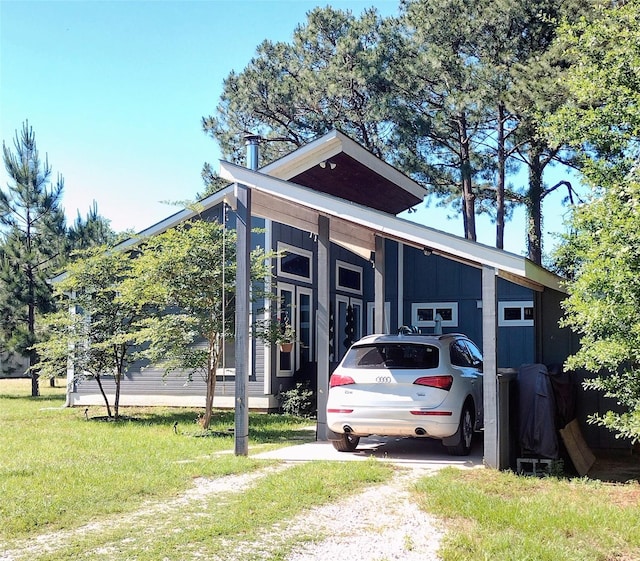 view of side of home with a yard and an attached carport
