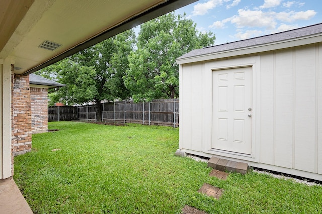 view of yard with a fenced backyard, an outdoor structure, and a shed